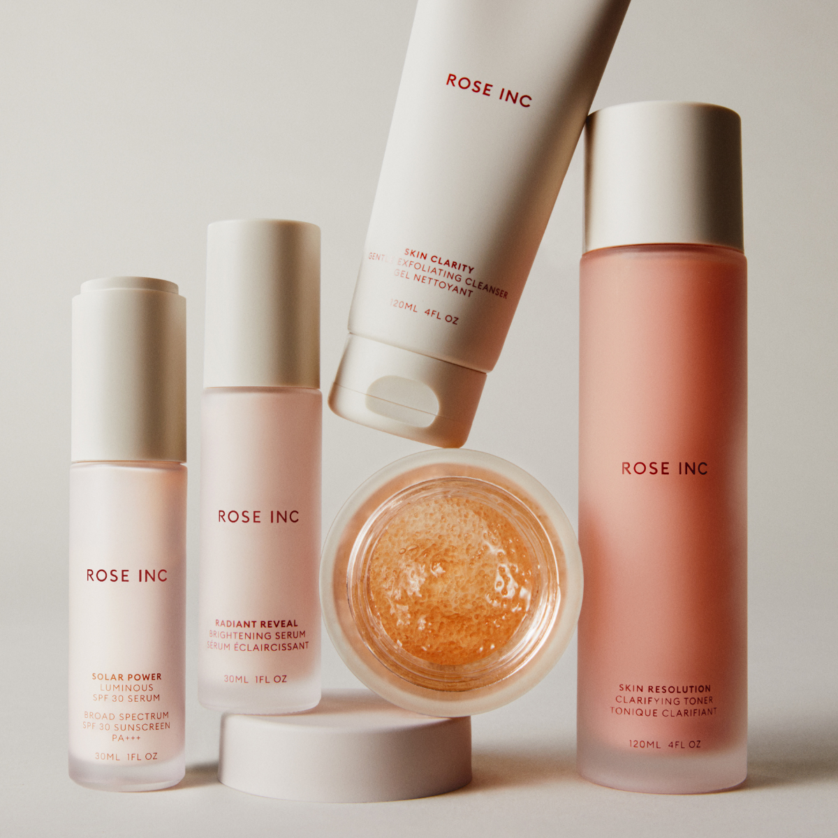 Model applying skincare on clean skin.